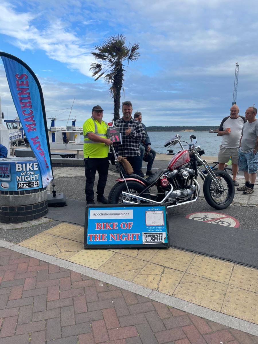 Biker recieving prize for winning bike of the night at Poole Quay dream machines 